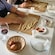 Two people making pasta noodles in a cooking class in Gragnano, Italy